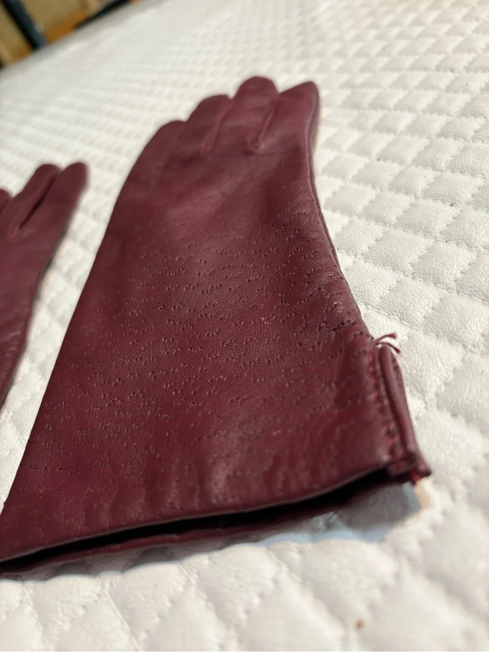 maroon leather gloves feature a distinctive textured perforated pattern 6.5